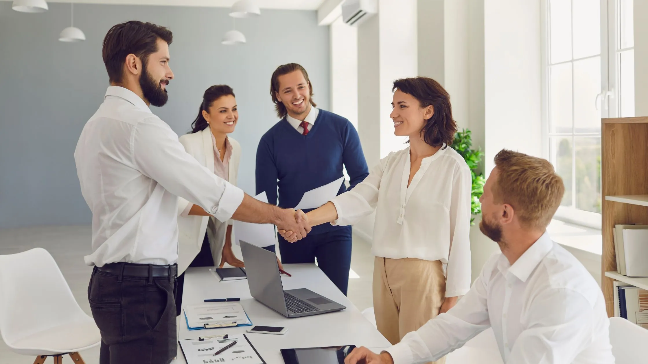 Business professionals shaking hands after a healthcare consulting discussion